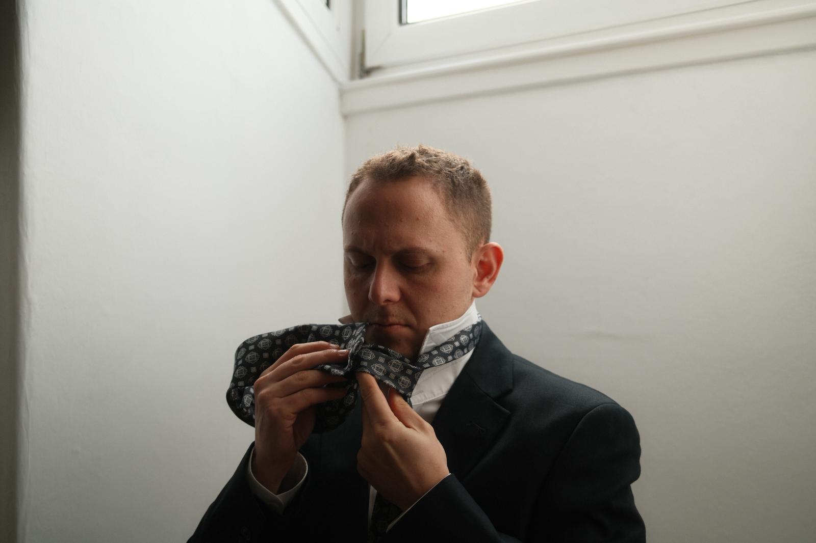 Michael Rice adjusting his tie